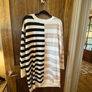 Striped Knit Sweater dress in beige, black, and White stripes.